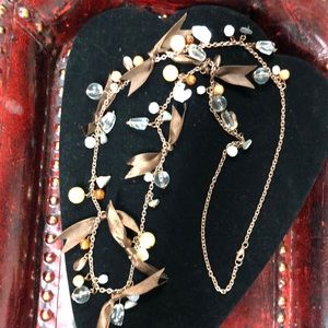 copper colored chain brown ribbon and a multitude of different stones 18 inches